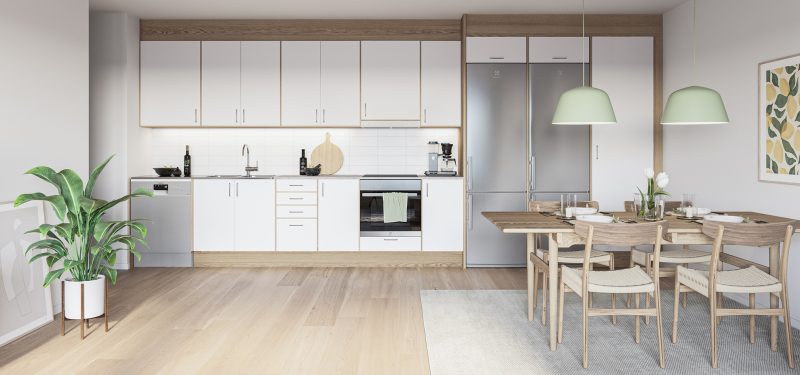 interiör visualisering av ett modernt kök och matplats. Köksdelen har vita skåp med trädetaljer och rostfria vitvaror, inklusive en diskmaskin, ugn och kyl/frys. Matplatsen har ett träbord och stolar, upplyst av två ljusgröna taklampor. Designen är minimalistisk och funktionell, typisk för nybyggda lägenheter.